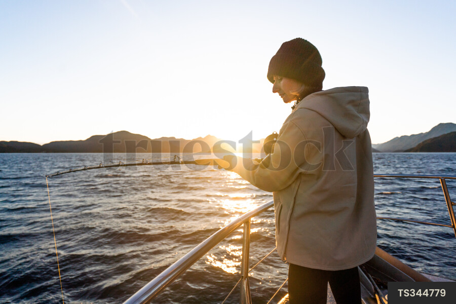 Woman fishing on boat
