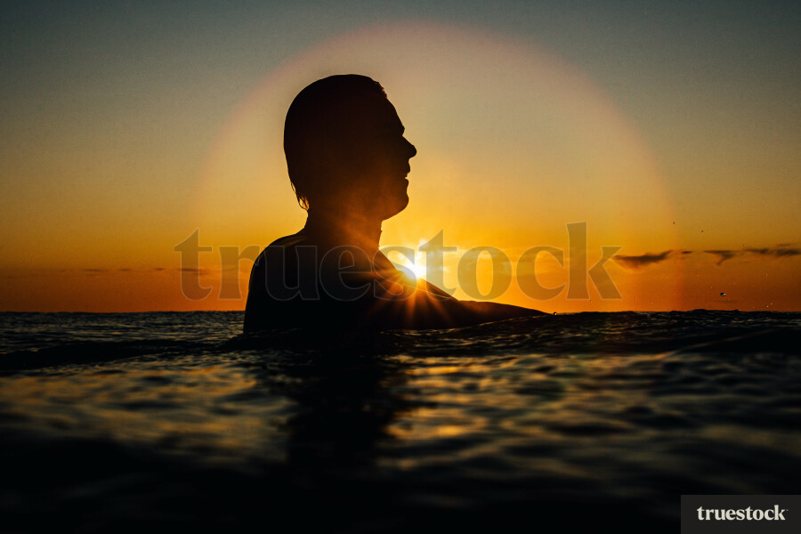 Surfers in Ocean at Sunrise