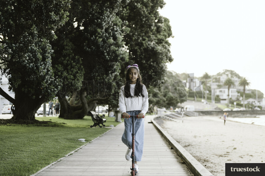Young Girl Riding on Scooter