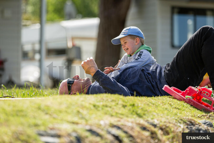 Dad and son playing on the grass