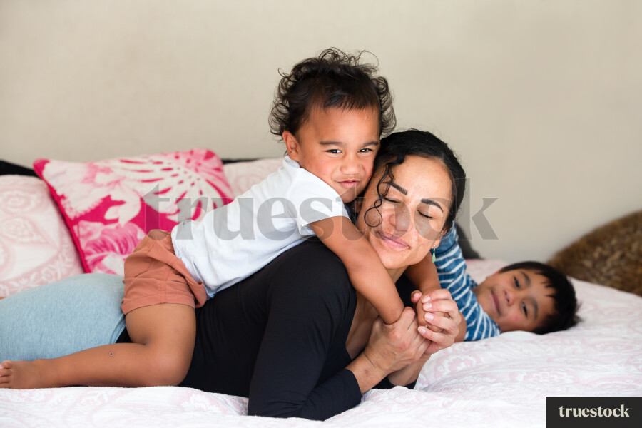 Mother and Sons on Bed