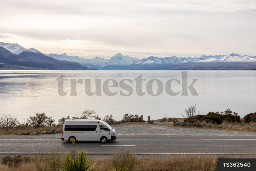 Vehicle Driving Next to Lake