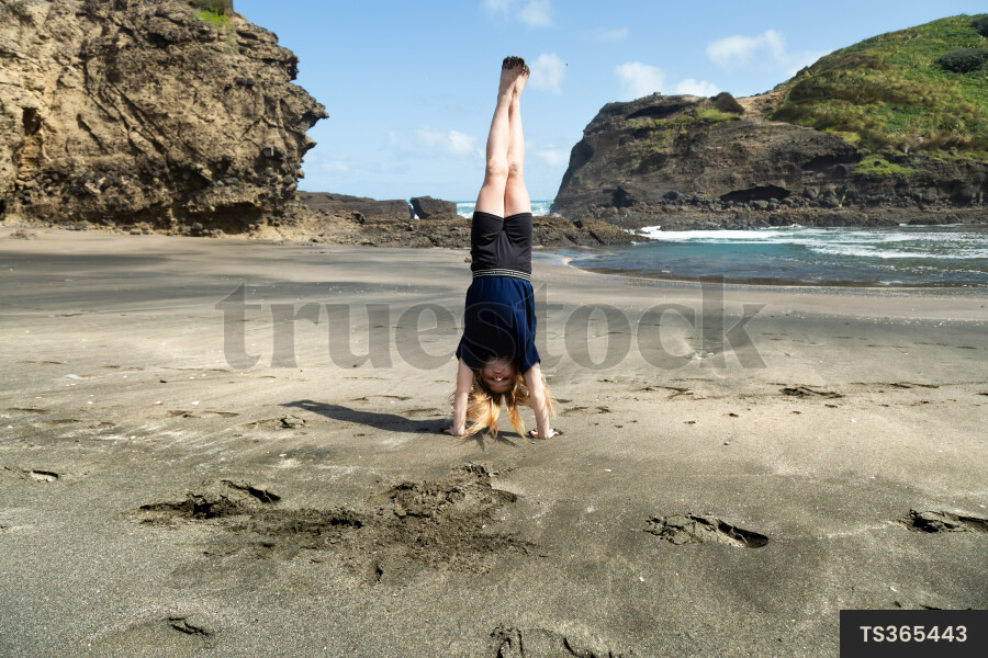 Girl playing at Piha Beach