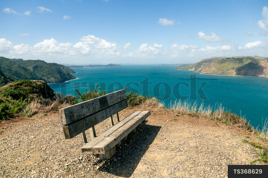 Bench on hill by coast
