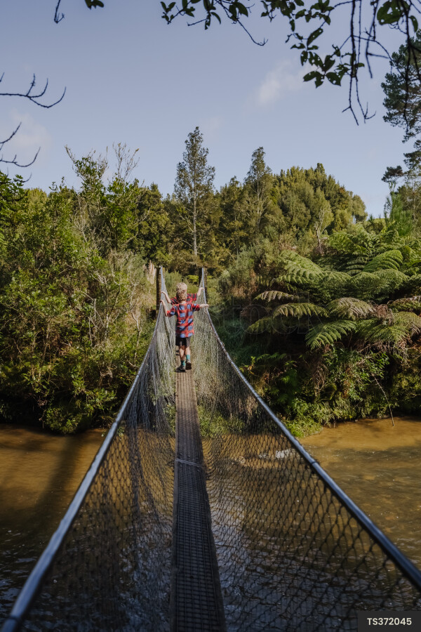 Boys walking on bridge