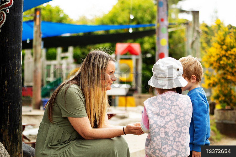 Teacher and students on kindergarten playground