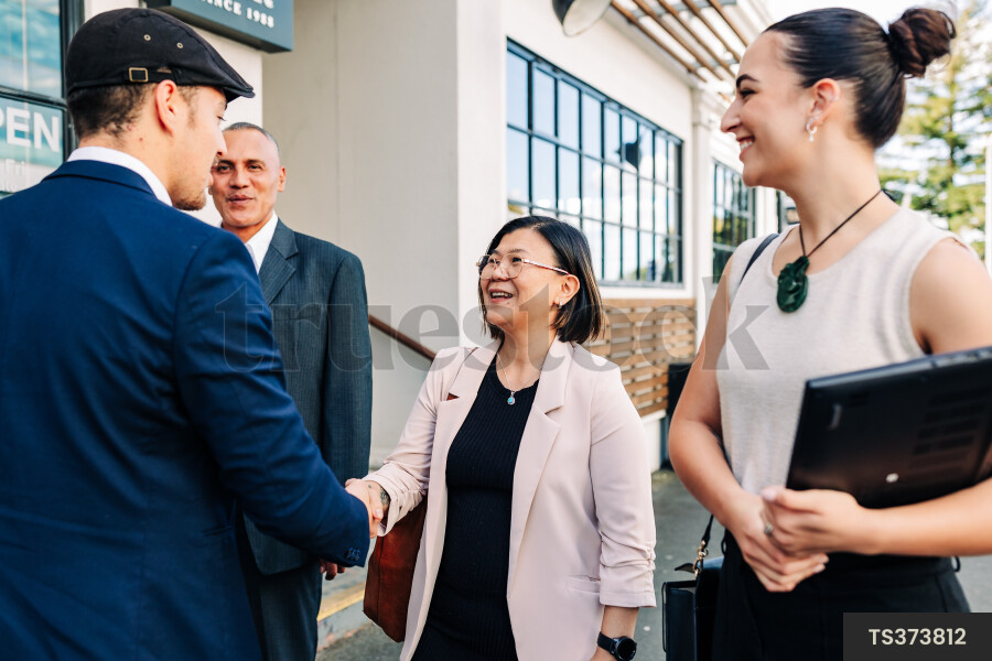 Smiling businesspeople shaking hands
