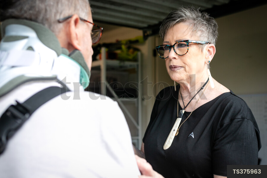 Health carer with patient in garage