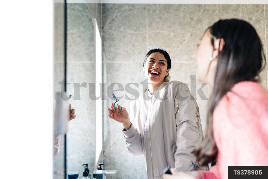Friends getting ready in bathroom