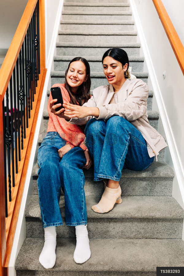 Friends taking selfie on staircase