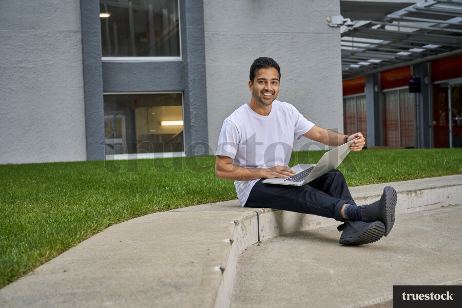 Student Using Laptop on Campus