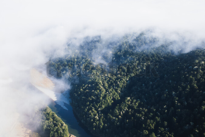 Aerial view of clouds above forest in Fiordland National Park