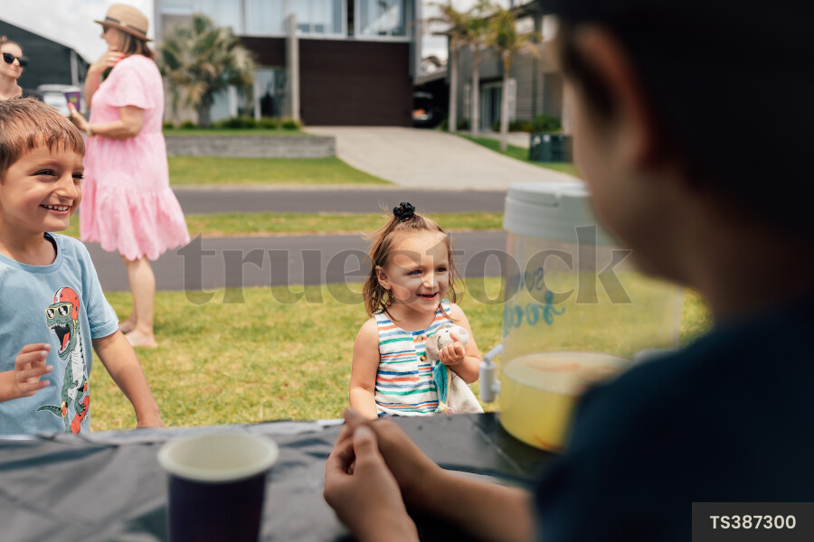 Kids Buying Lemonade at Lemonade Stand