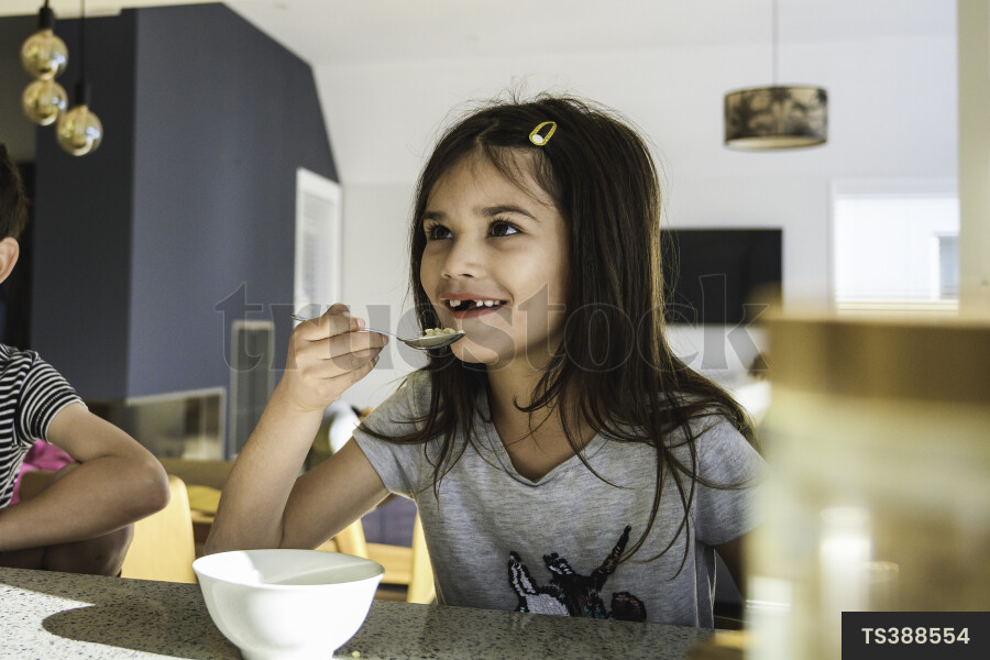 Young Kids Eating Breakfast in Kitchen