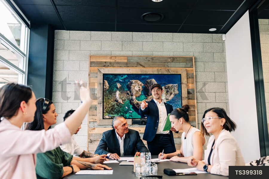Businesspeople gesturing during meeting in boardroom