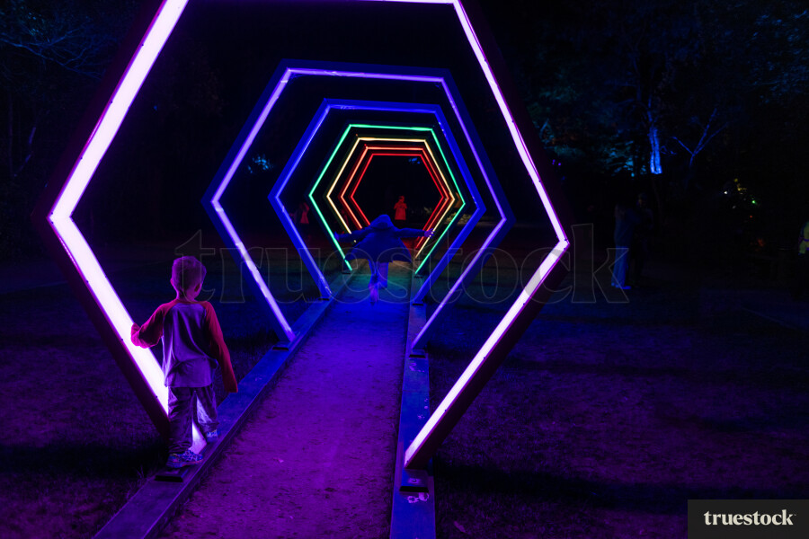 Boys Running Through Light Installation in Taranaki