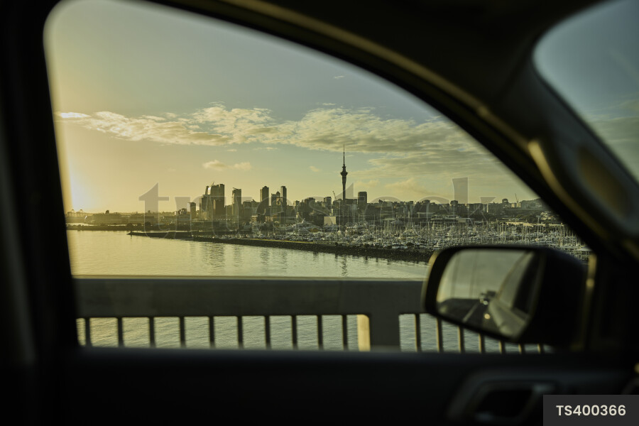 City during sunset from car on bridge