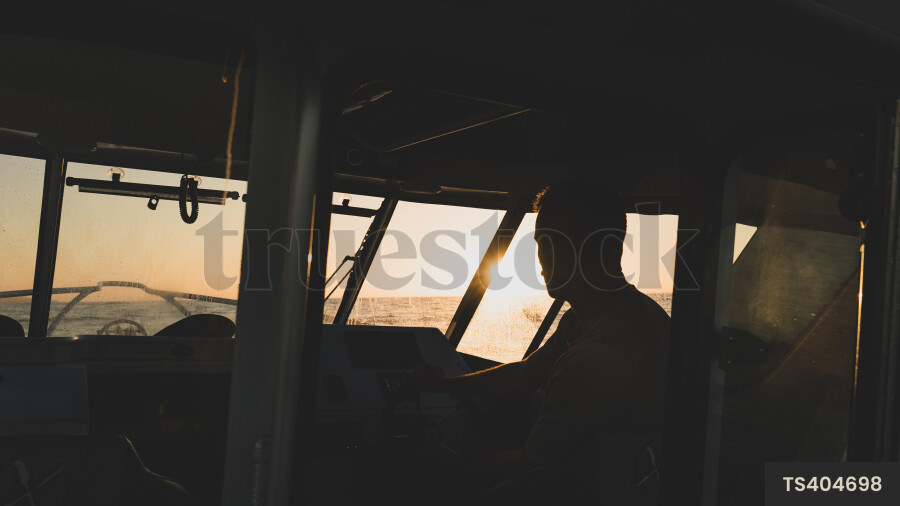 Man on boat at sunset