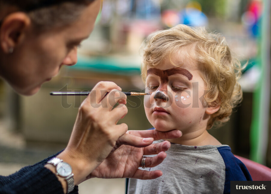 Toddler getting face painted