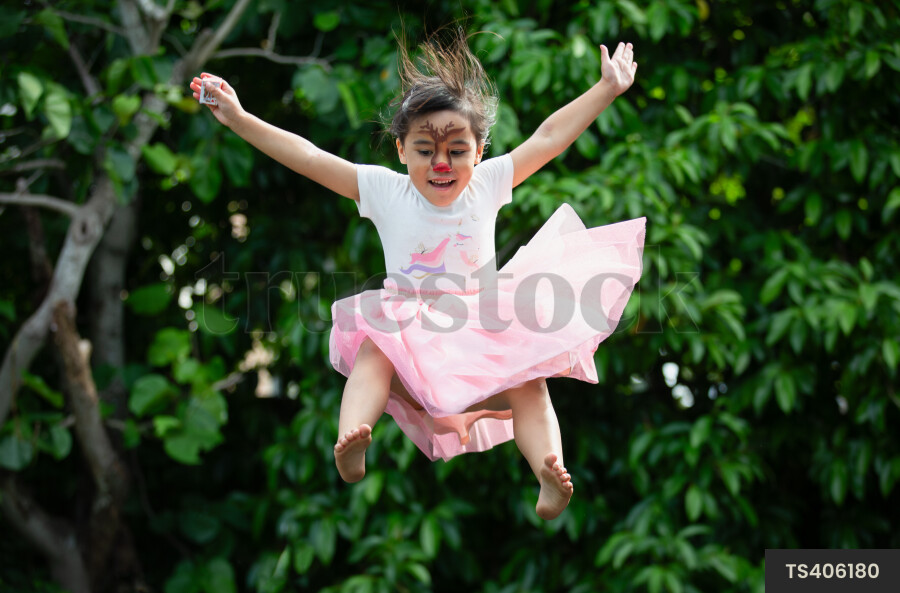 TS406180 Girl Jumping with Face Paint by Emma Diack - Truestock
