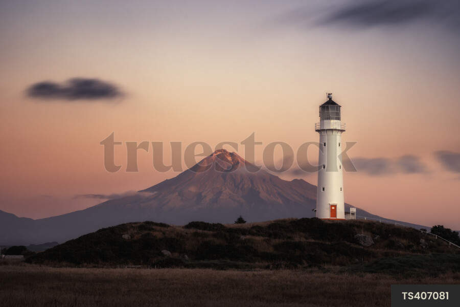 Lighthouse by Mount Taranaki at sunset