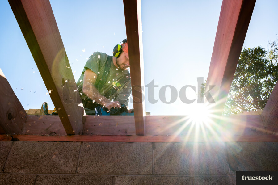 Worker Sanding Wood