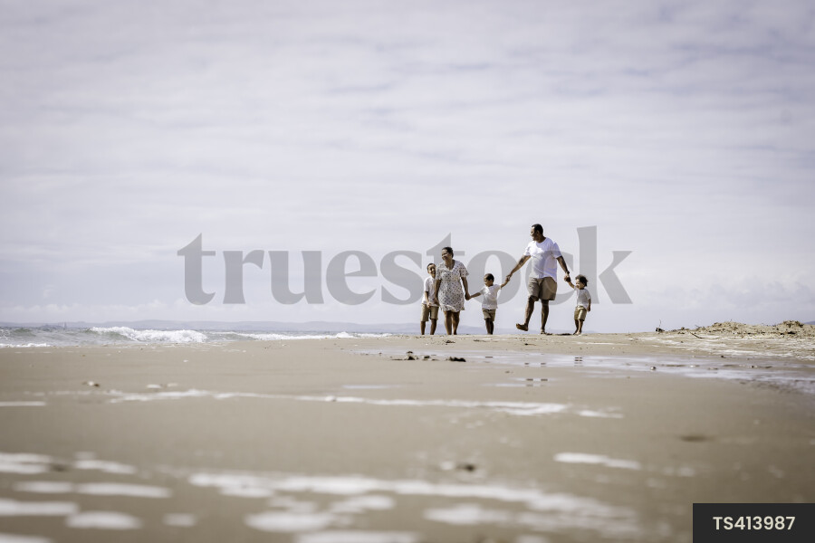Family Walking Along Beach