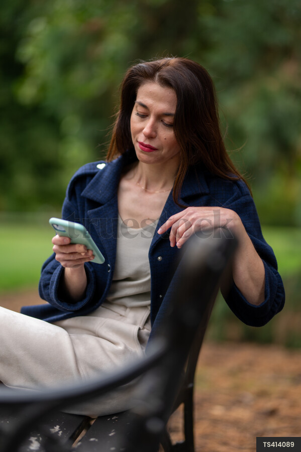 Woman sitting on park bench