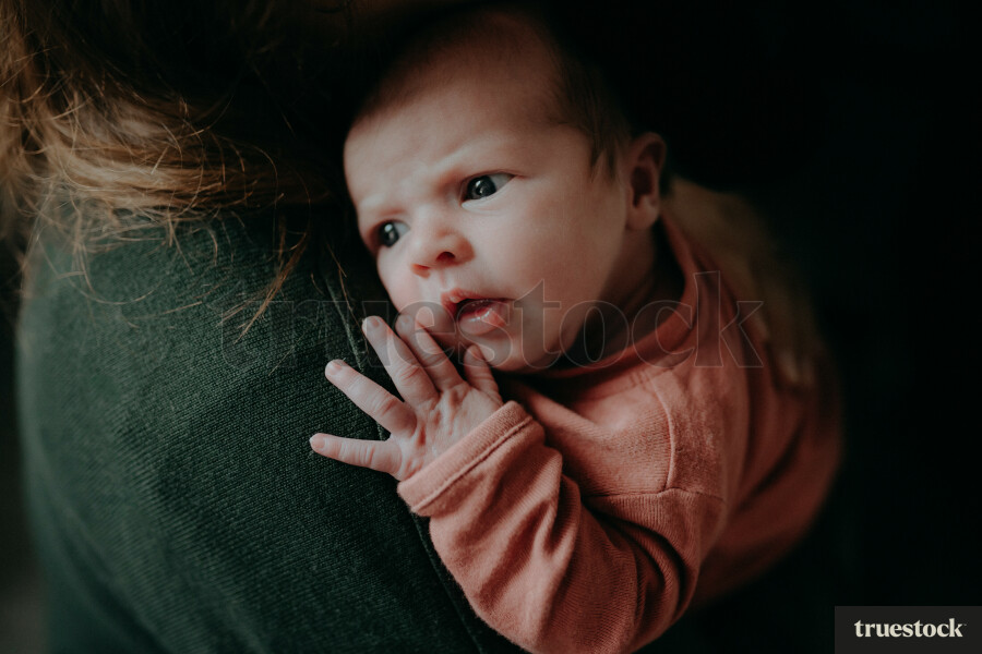 Mother holding newborn on the chest