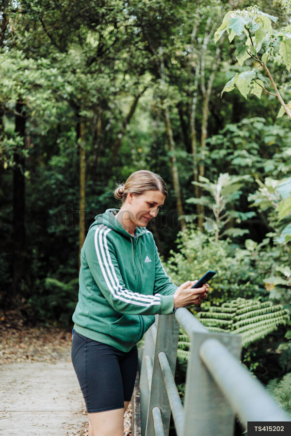 Woman Using Phone on Hike