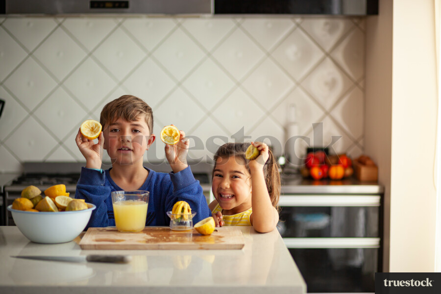Young children making lemondade