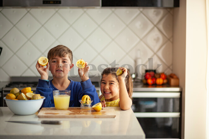Young children making lemondade