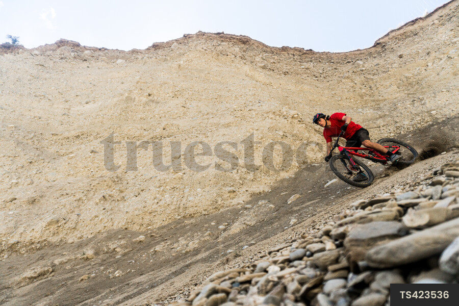 Man mountain biking on dirt trail