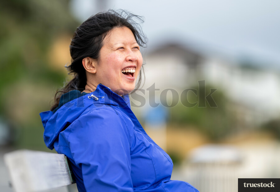 Chinese woman sitting on bench