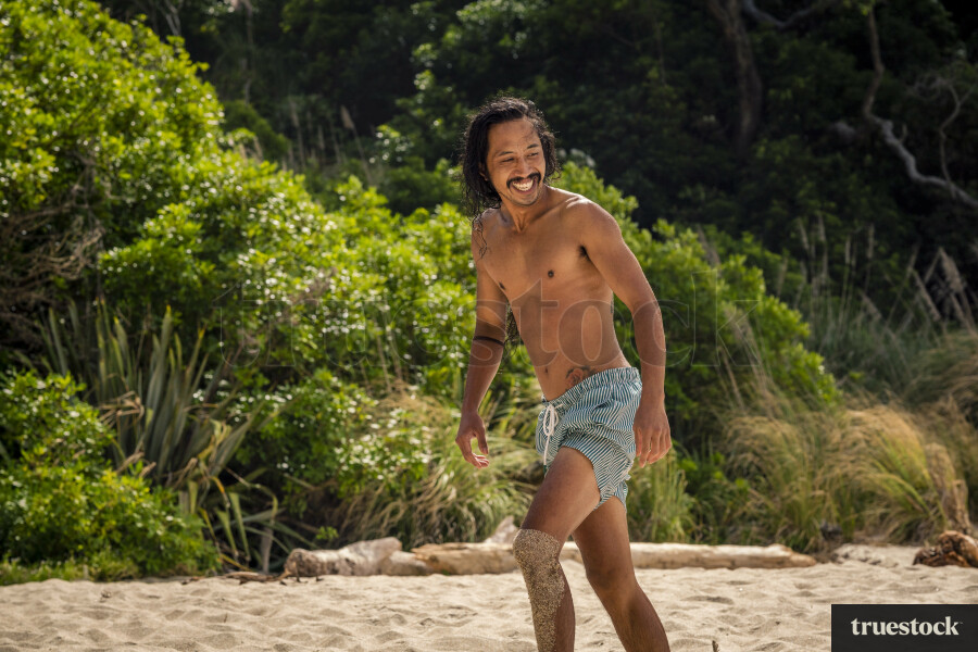Man Walking Along Pokohino Beach