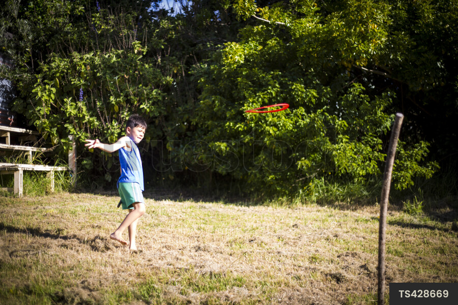 Boy playing with toy in garden
