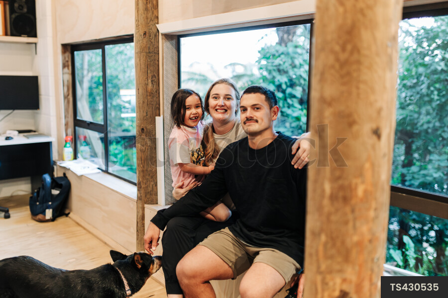 Portrait of happy young family in house