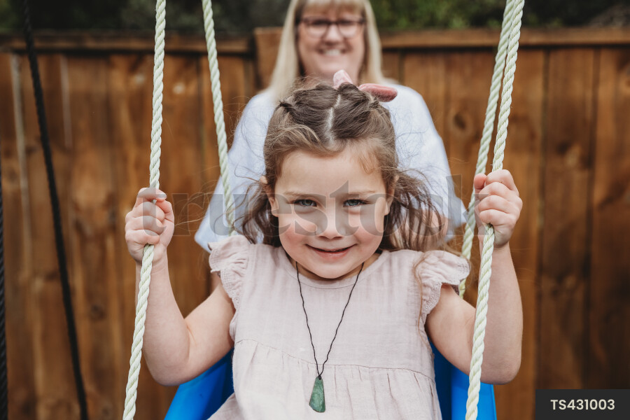 Young Girl on Playground and Swing