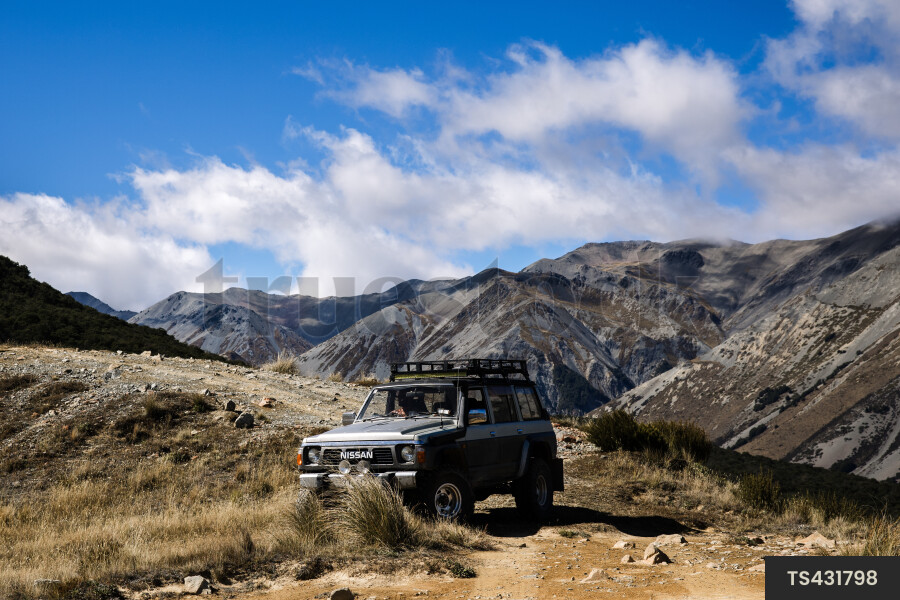 Four wheel drive on off-road vehicle on unpaved road in mountain