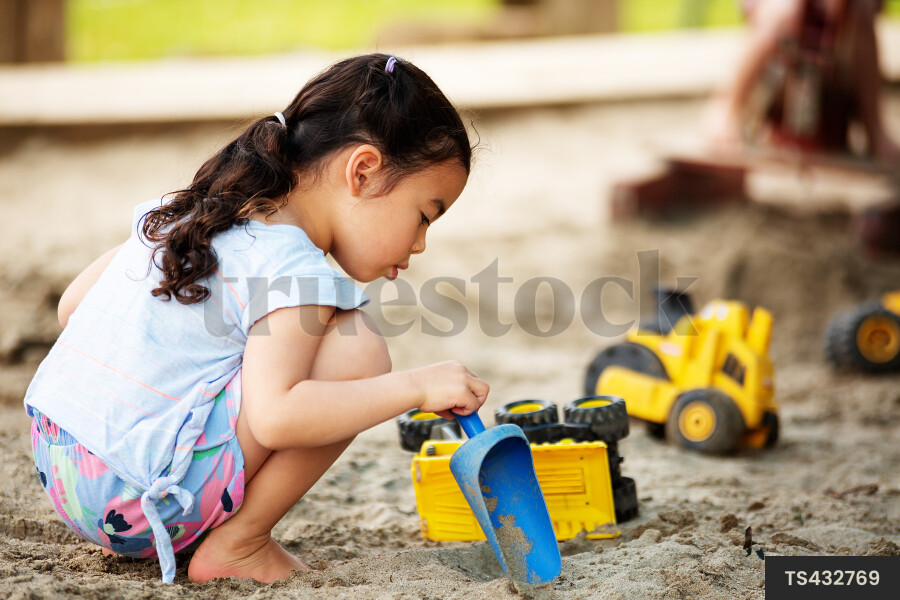 Girl playing in sandpit