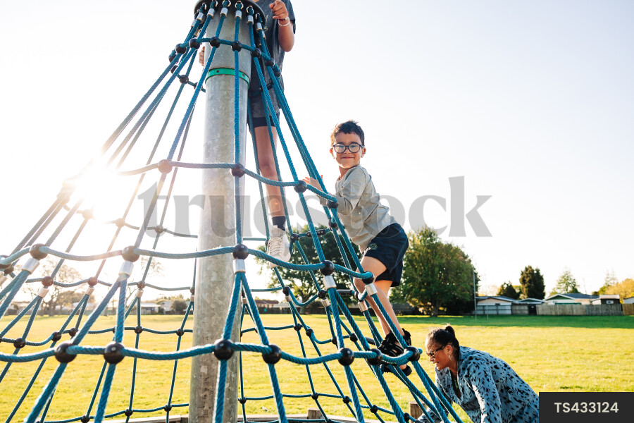Children climbing jungle gym in park