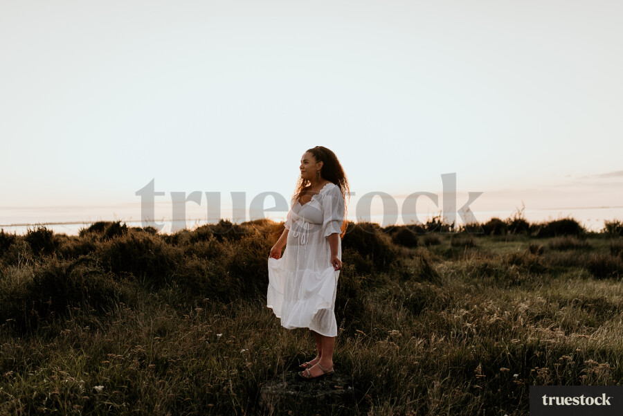Woman Standing in Field for Maternity Shoot