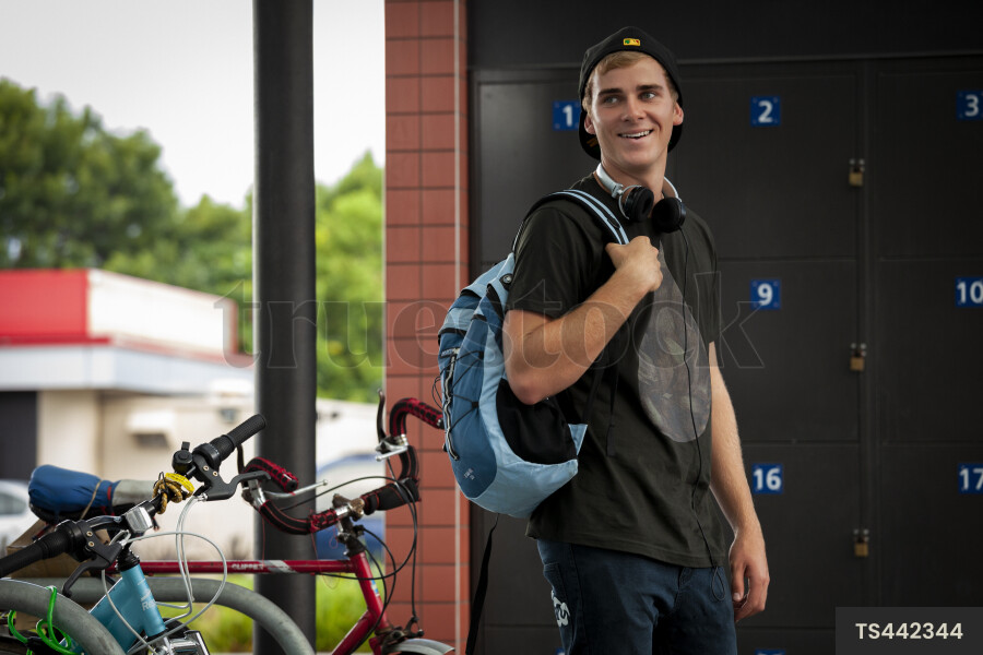 Man Packing Backpack by Bikes