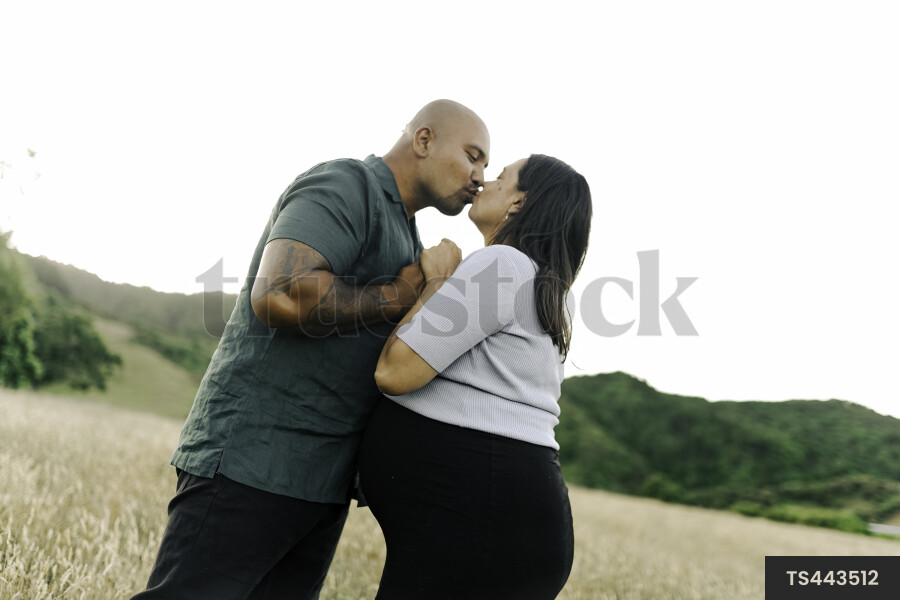 Husband and Pregnant Wife in Field