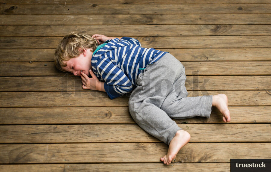 Upset child on wooden deck