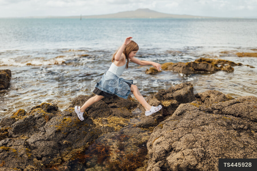 People Exploring Rocks TS445928 Young girl exploring rocks during low tide by Mikey MacKinven ...