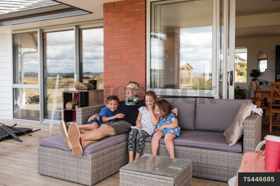 Man sitting with his grandchildren