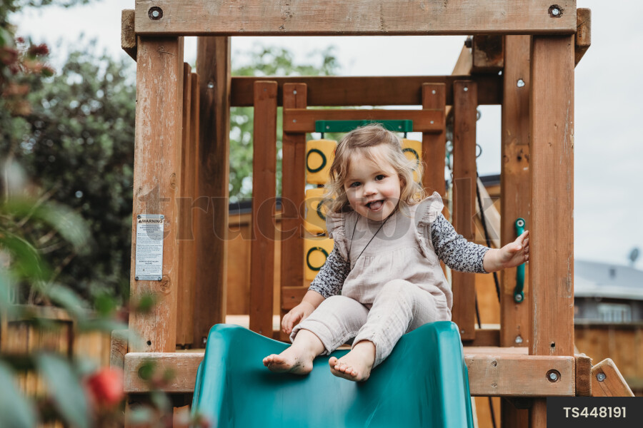 Young Girl on Playground and Swing