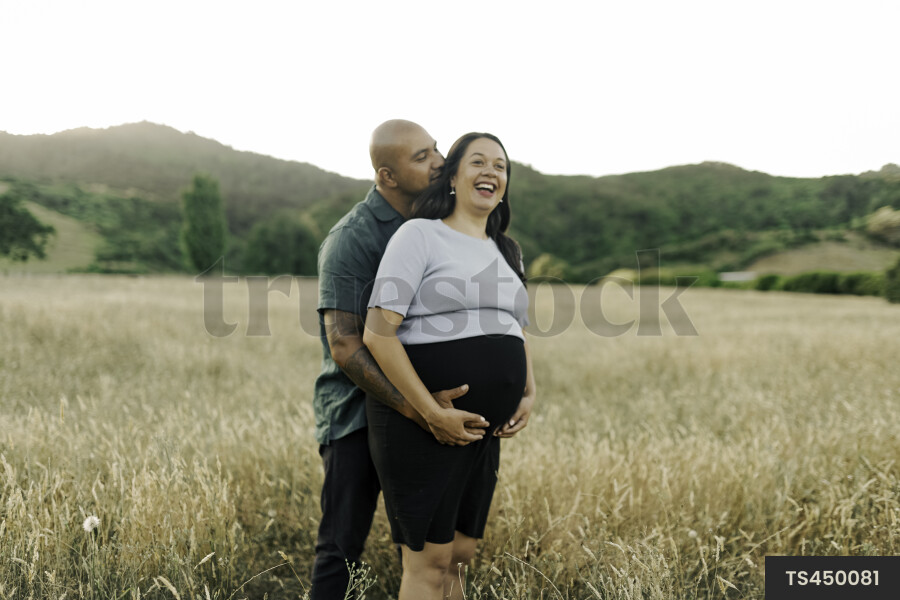 Husband and Pregnant Wife in Field