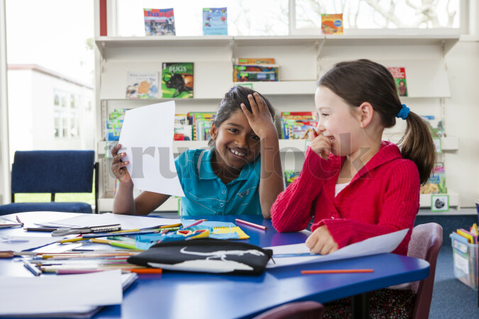Young Girls Drawing in Class